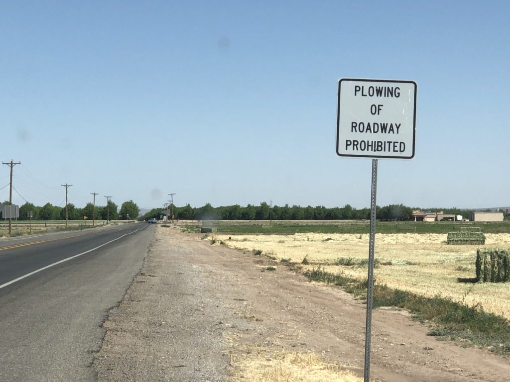 Highway sign reading “Plowing of roadway prohibited.”