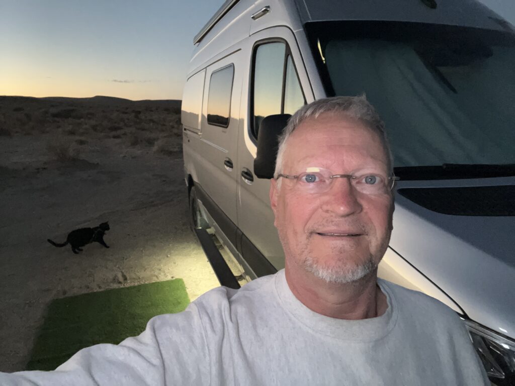 Author posing next to his camper van.